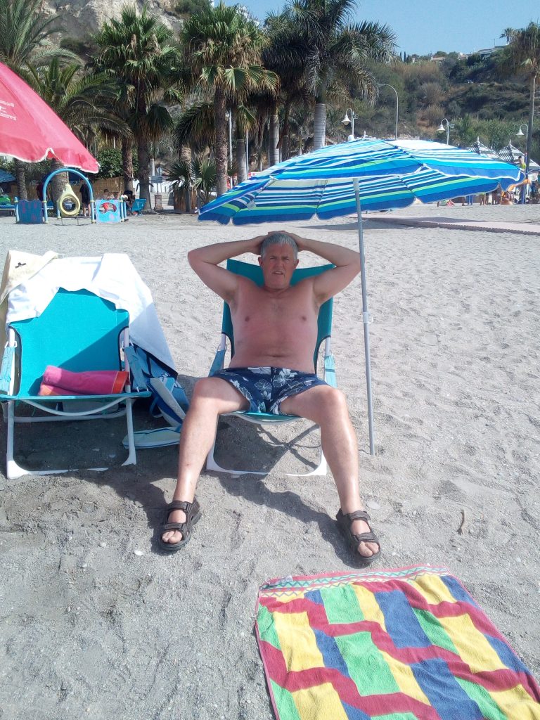Tourist relaxing on Burriana Beach in Nerja